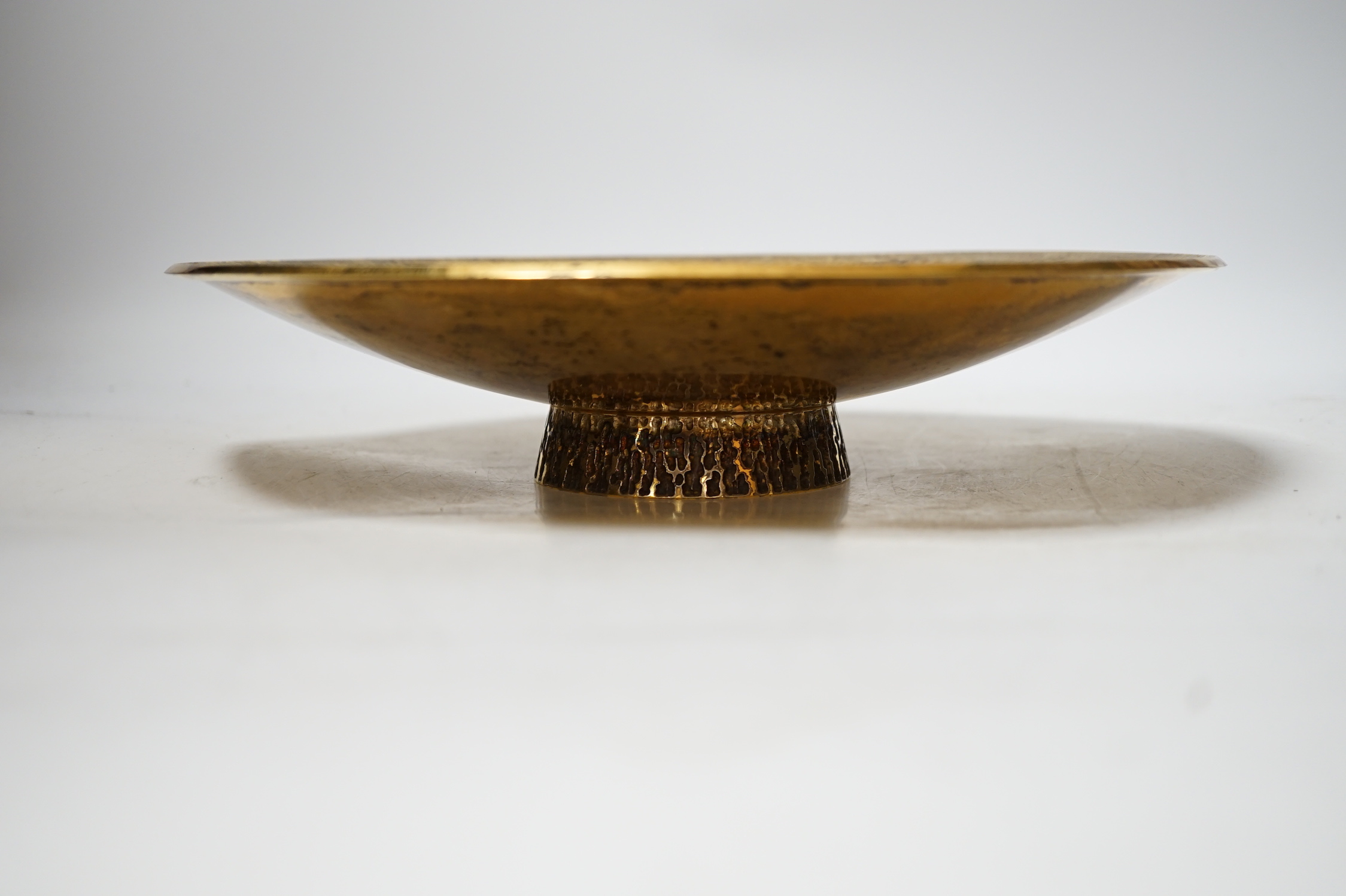 A modern planished silver gilt shallow dish, on circular foot, maker TS, London, 1996, 28.2cm, 24.4oz.